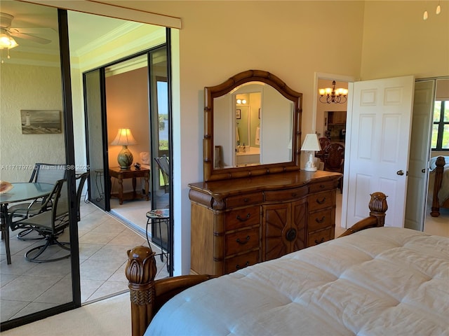 tiled bedroom with ornamental molding, a closet, and a chandelier