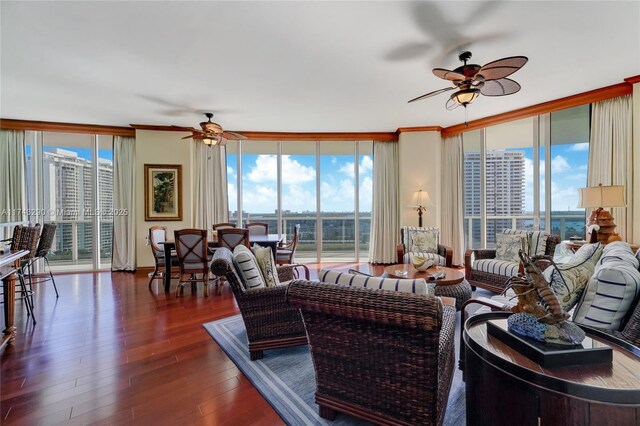 living area featuring a ceiling fan, dark wood-style floors, and expansive windows