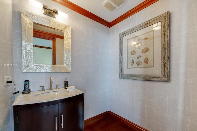 bathroom featuring vanity, ornamental molding, tile walls, and visible vents