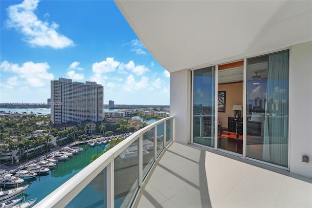 balcony featuring a water view and a city view
