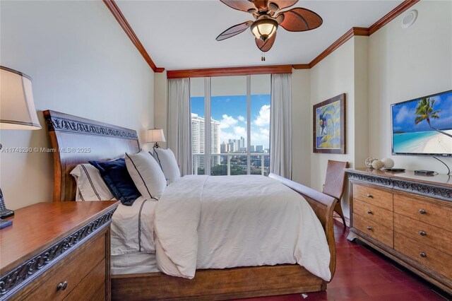 bedroom featuring dark wood finished floors, crown molding, and ceiling fan