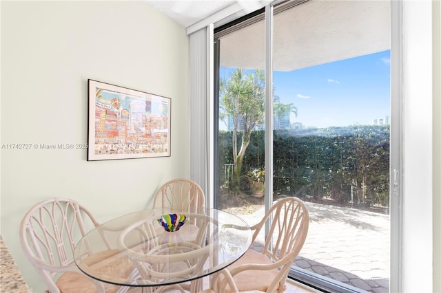 dining area with a wall of windows