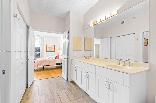 bathroom featuring vanity and a textured ceiling