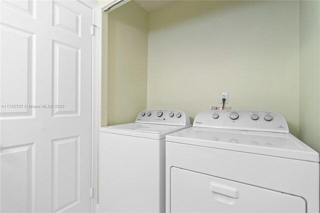 washroom featuring washer and clothes dryer