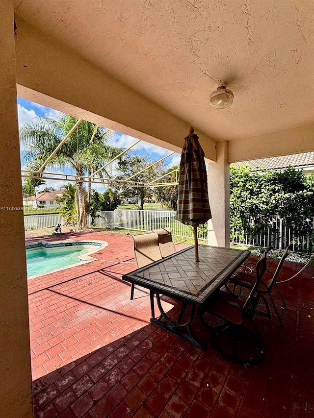 view of patio / terrace with a fenced in pool