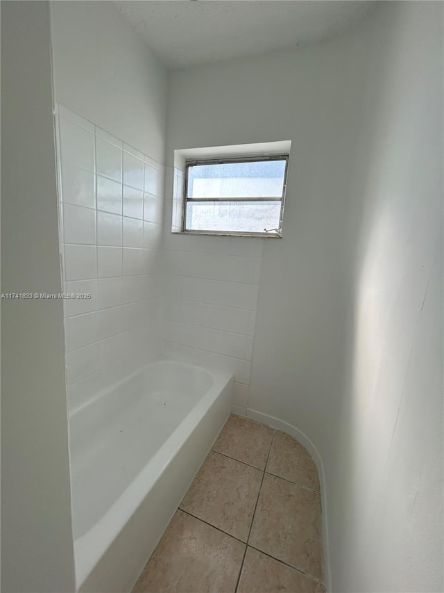 bathroom featuring a tub to relax in and tile patterned floors