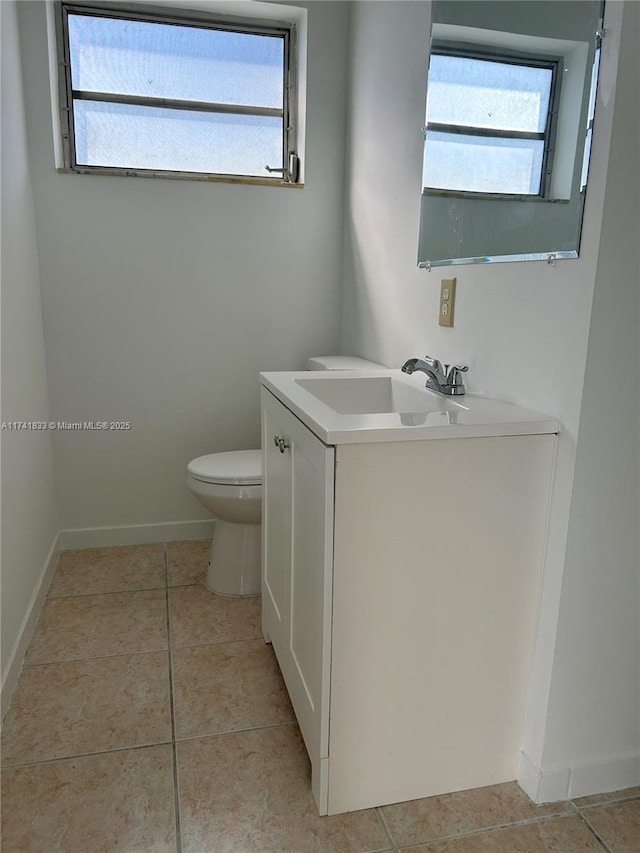 bathroom featuring tile patterned floors, vanity, and toilet