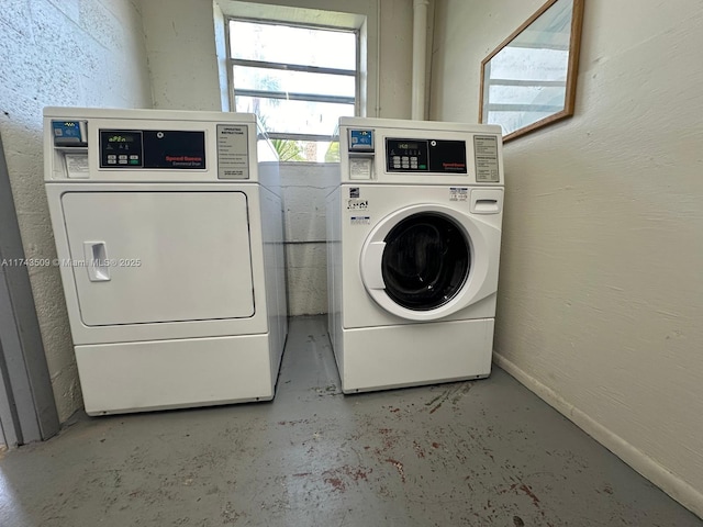 clothes washing area with washing machine and clothes dryer