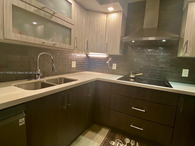 kitchen featuring sink, backsplash, black appliances, light brown cabinetry, and wall chimney exhaust hood