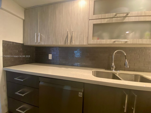 kitchen featuring dishwasher, sink, light brown cabinetry, and decorative backsplash