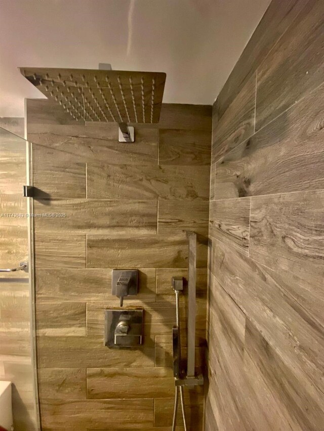 bedroom with hardwood / wood-style flooring and wooden walls