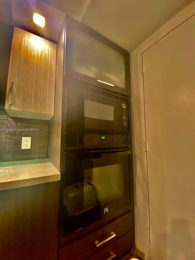 interior details featuring decorative backsplash and black appliances