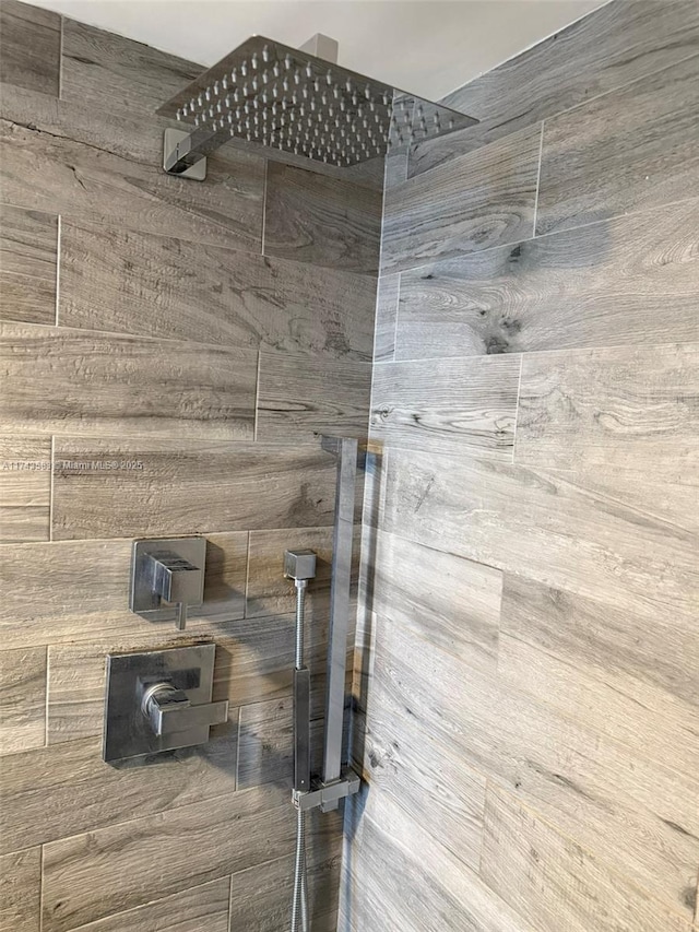 interior details with a tile shower