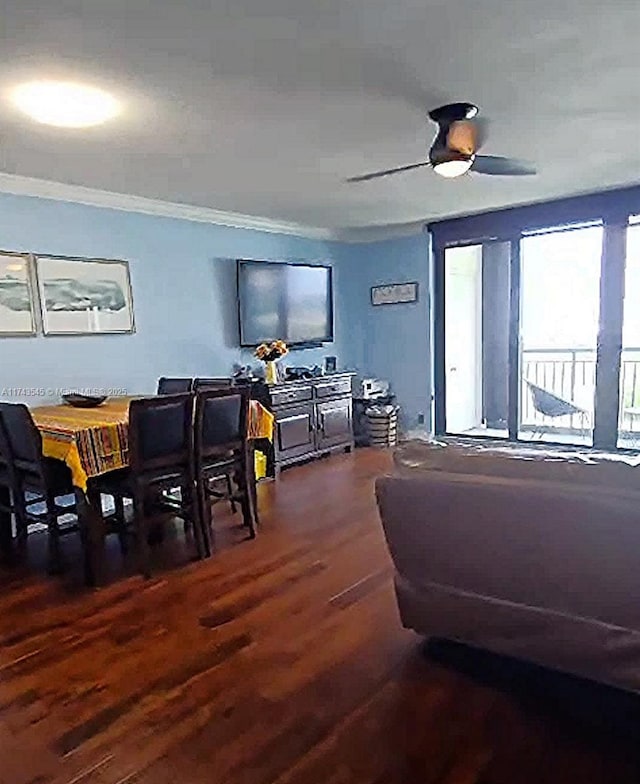 dining area featuring dark hardwood / wood-style flooring, crown molding, and ceiling fan