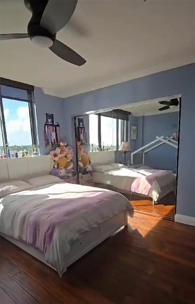 bedroom featuring hardwood / wood-style floors and ceiling fan