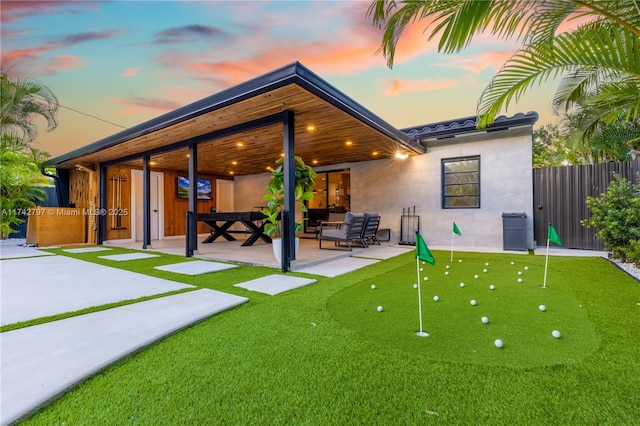 back of property with an outdoor hangout area and a patio area