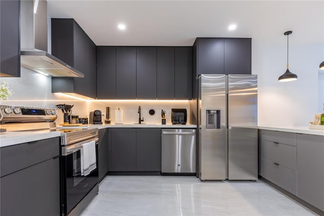 kitchen with sink, hanging light fixtures, gray cabinets, stainless steel appliances, and wall chimney range hood