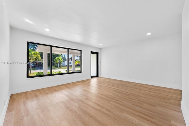 unfurnished room with light wood-type flooring