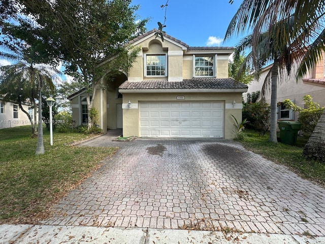 view of front of property with a garage and a front lawn