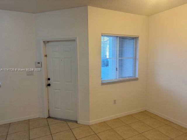 foyer entrance with light tile patterned floors