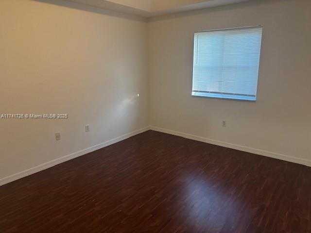 spare room featuring dark hardwood / wood-style flooring