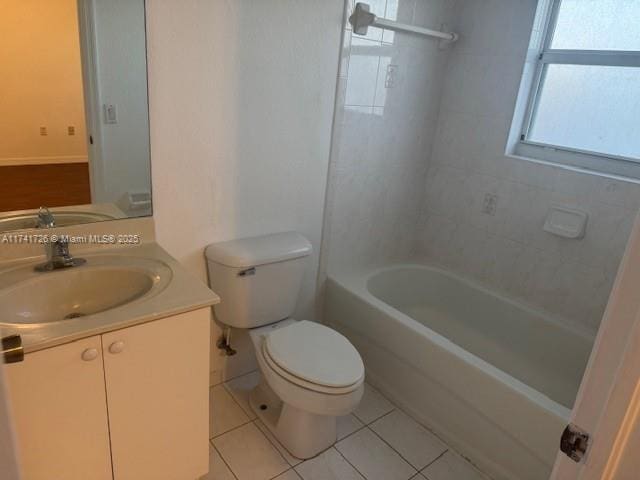 full bathroom featuring vanity, toilet, tiled shower / bath combo, and tile patterned flooring