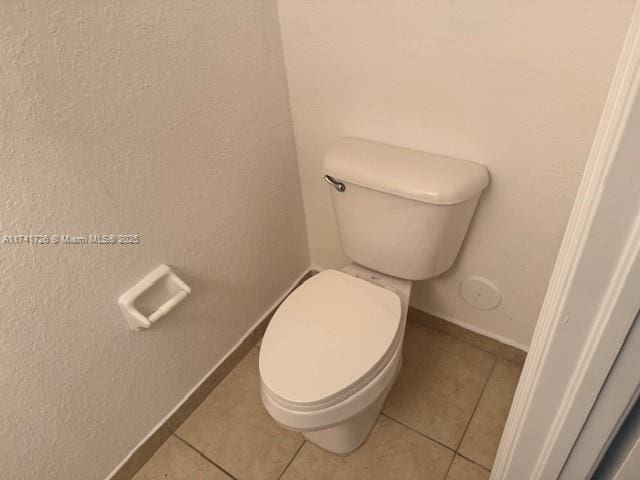 bathroom featuring tile patterned floors and toilet