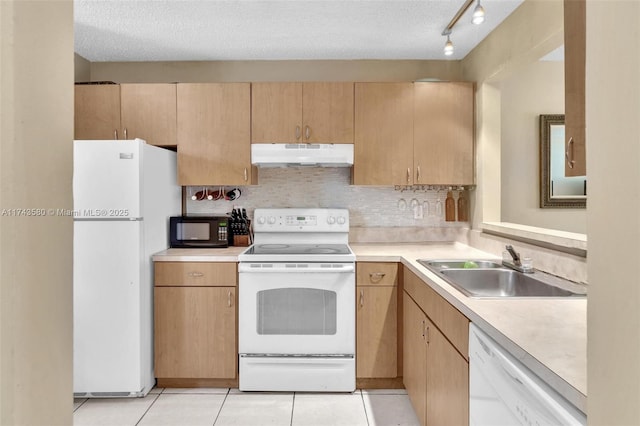 kitchen featuring light tile patterned flooring, white appliances, sink, and a textured ceiling