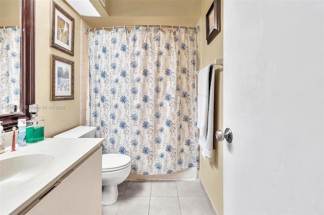 bathroom with a shower with curtain, vanity, tile patterned floors, and toilet