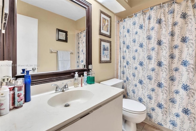 bathroom with walk in shower, tile patterned floors, vanity, and toilet