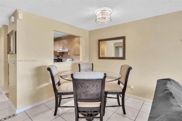 tiled dining area featuring a textured ceiling