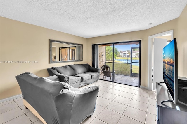 living room featuring light tile patterned floors and a textured ceiling