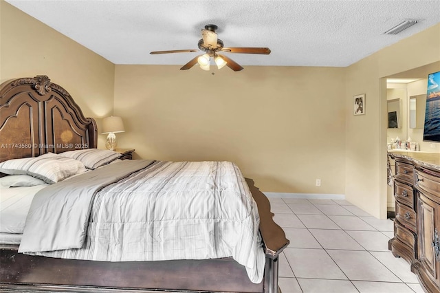 bedroom with light tile patterned floors, a textured ceiling, and ceiling fan