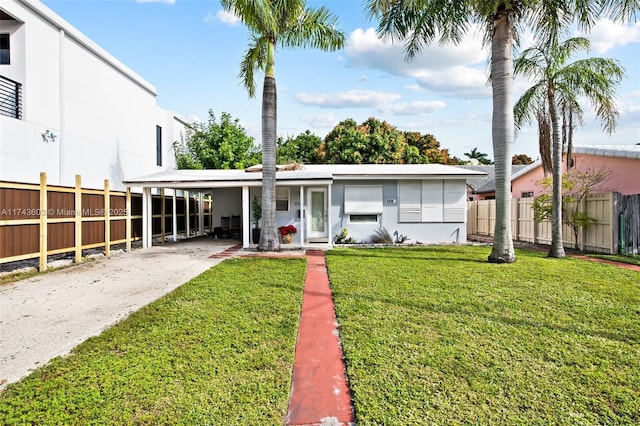 view of front facade featuring a front lawn and a carport