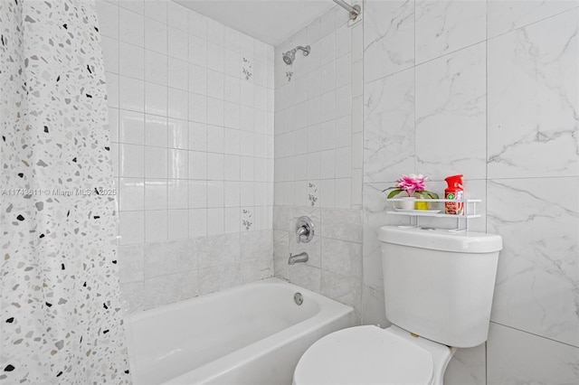 bathroom featuring toilet, tiled shower / bath combo, and tile walls