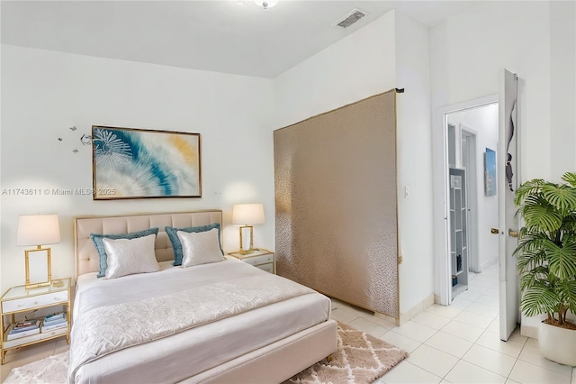 bedroom with light tile patterned floors