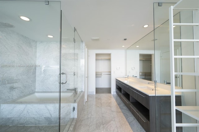 bathroom featuring plus walk in shower and vanity