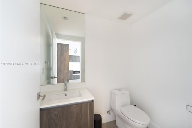 bathroom featuring vanity and toilet