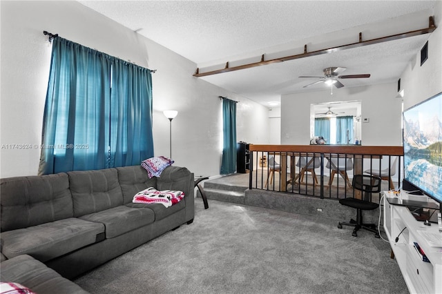 living area featuring carpet, visible vents, and a textured ceiling