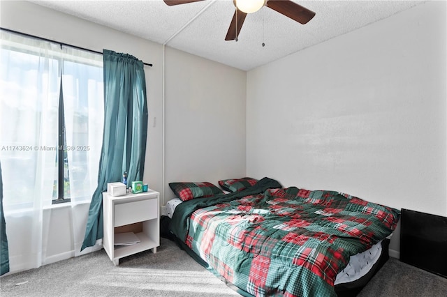 bedroom featuring carpet, ceiling fan, a textured ceiling, and baseboards