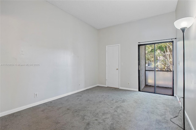 carpeted spare room with baseboards