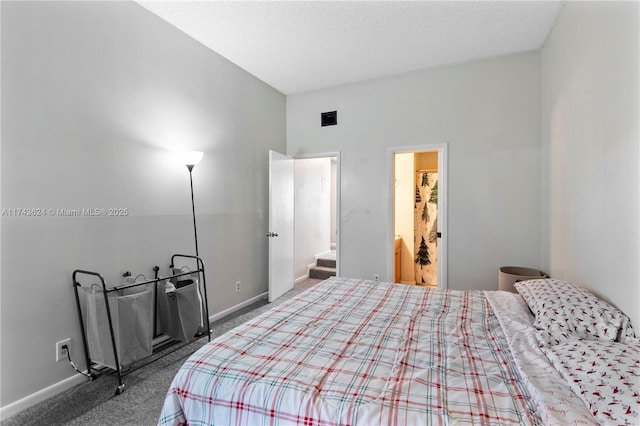 bedroom featuring carpet floors, baseboards, and a textured ceiling