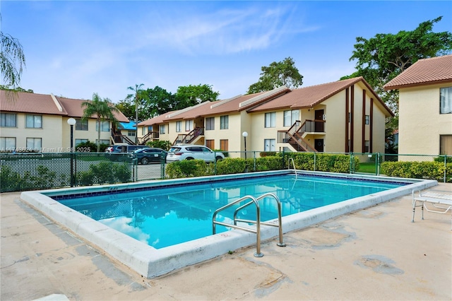 pool featuring a residential view and fence