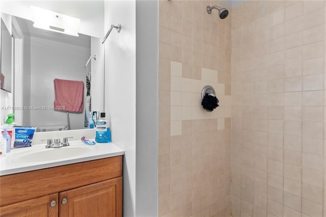 bathroom featuring vanity, toilet, and tiled shower