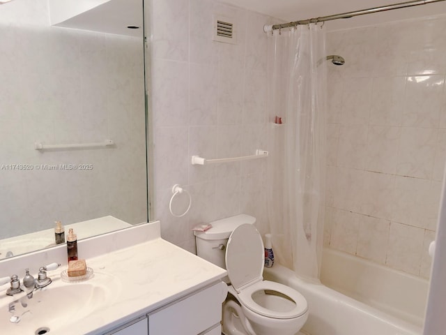 full bathroom featuring tile walls, vanity, toilet, and shower / bath combo