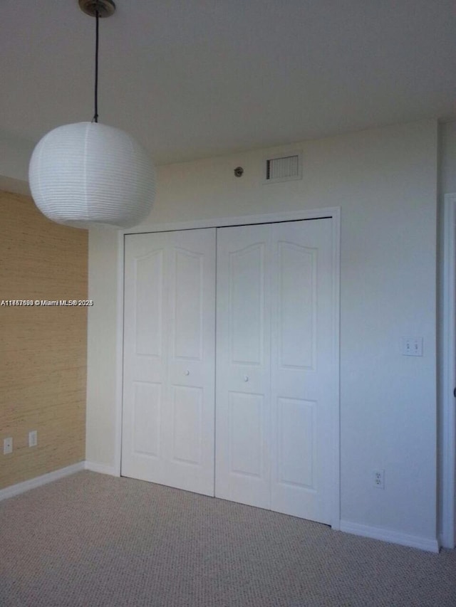 unfurnished bedroom featuring carpet floors and a closet