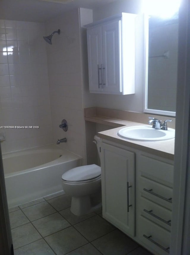 full bathroom featuring tiled shower / bath, toilet, tile patterned floors, and vanity