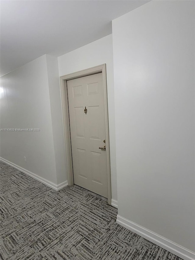 unfurnished room featuring baseboards