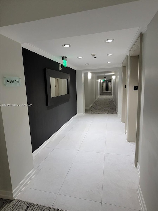 corridor featuring light tile patterned floors, recessed lighting, crown molding, and baseboards
