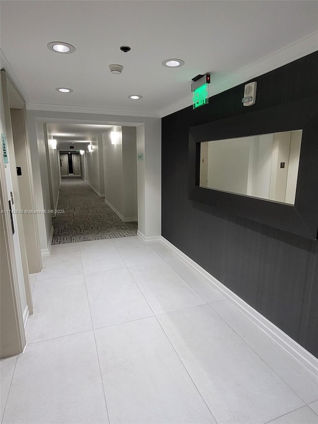 hall with light tile patterned floors, recessed lighting, crown molding, and baseboards